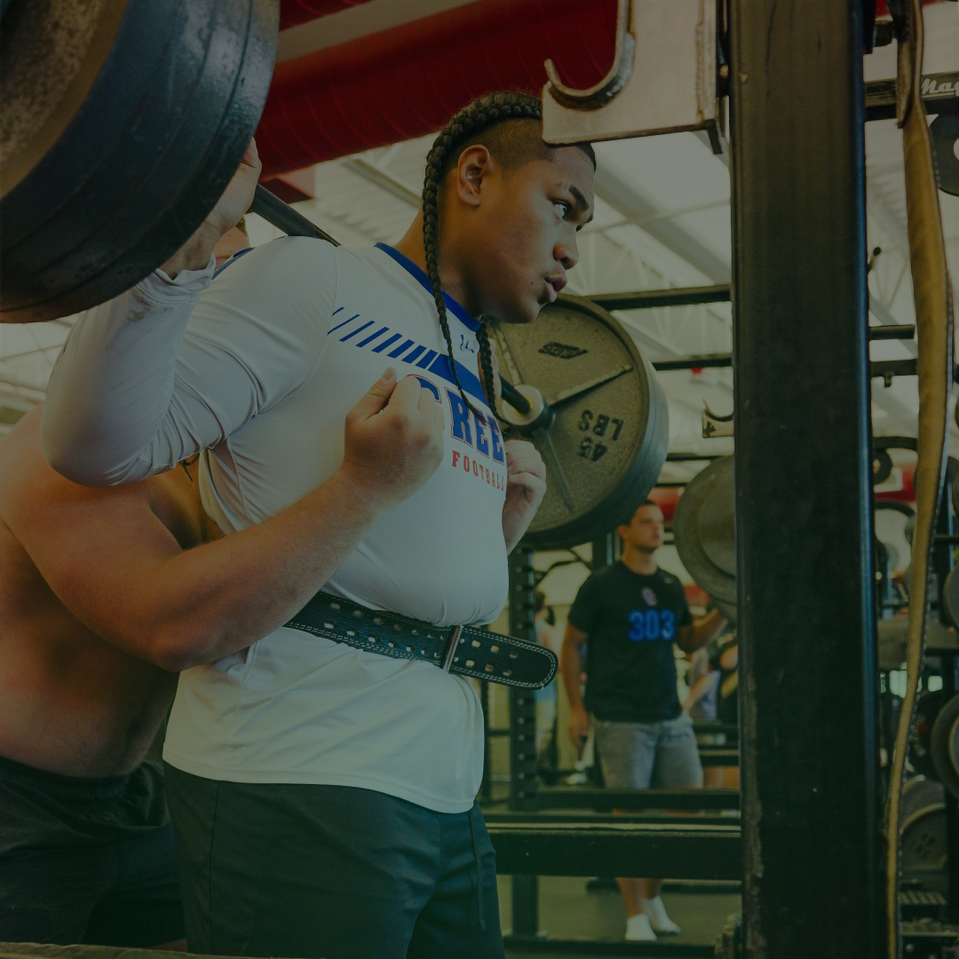 Athlete training with teammates in a performance gym